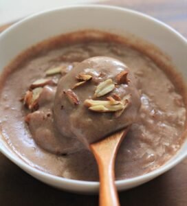 A bowl of delicious ragi porrridge garnished with nuts