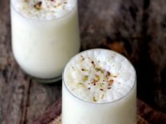 A glass of Barnyard Millet Sweet Lassi garnished with mint leaves, showcasing a refreshing and healthy summer drink.