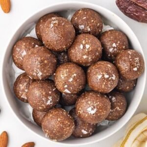 A plate with soft ragi laddoos with added coconut shreds